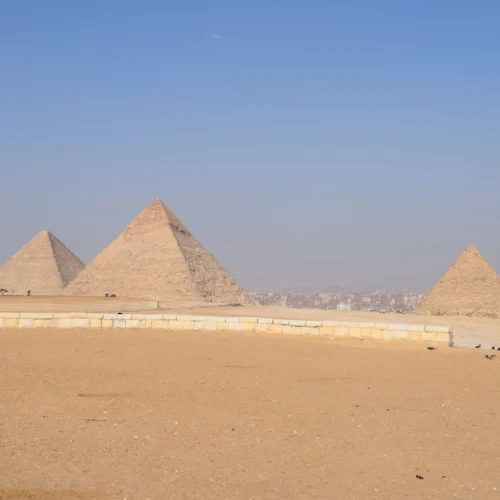 The three pyramids of Giza on the plateau above the desert