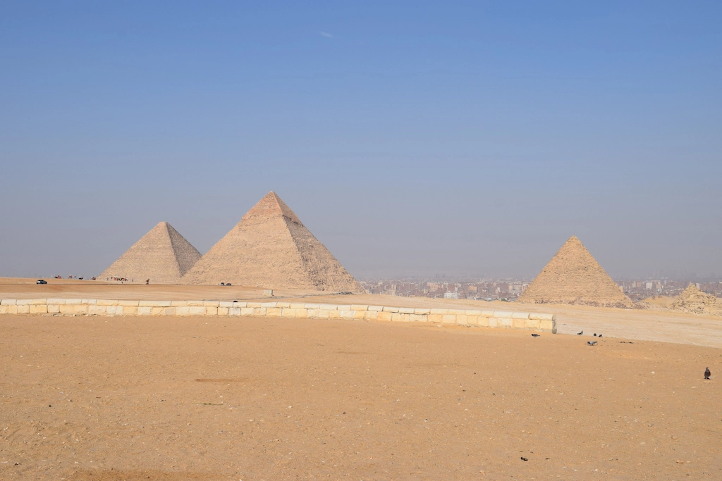 The three pyramids of Giza on the plateau above the desert