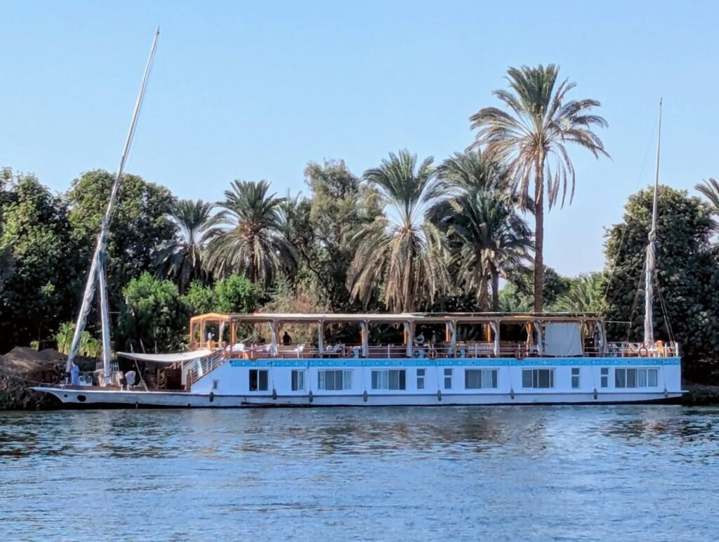 Dahabeya moored by palm trees on the Nile