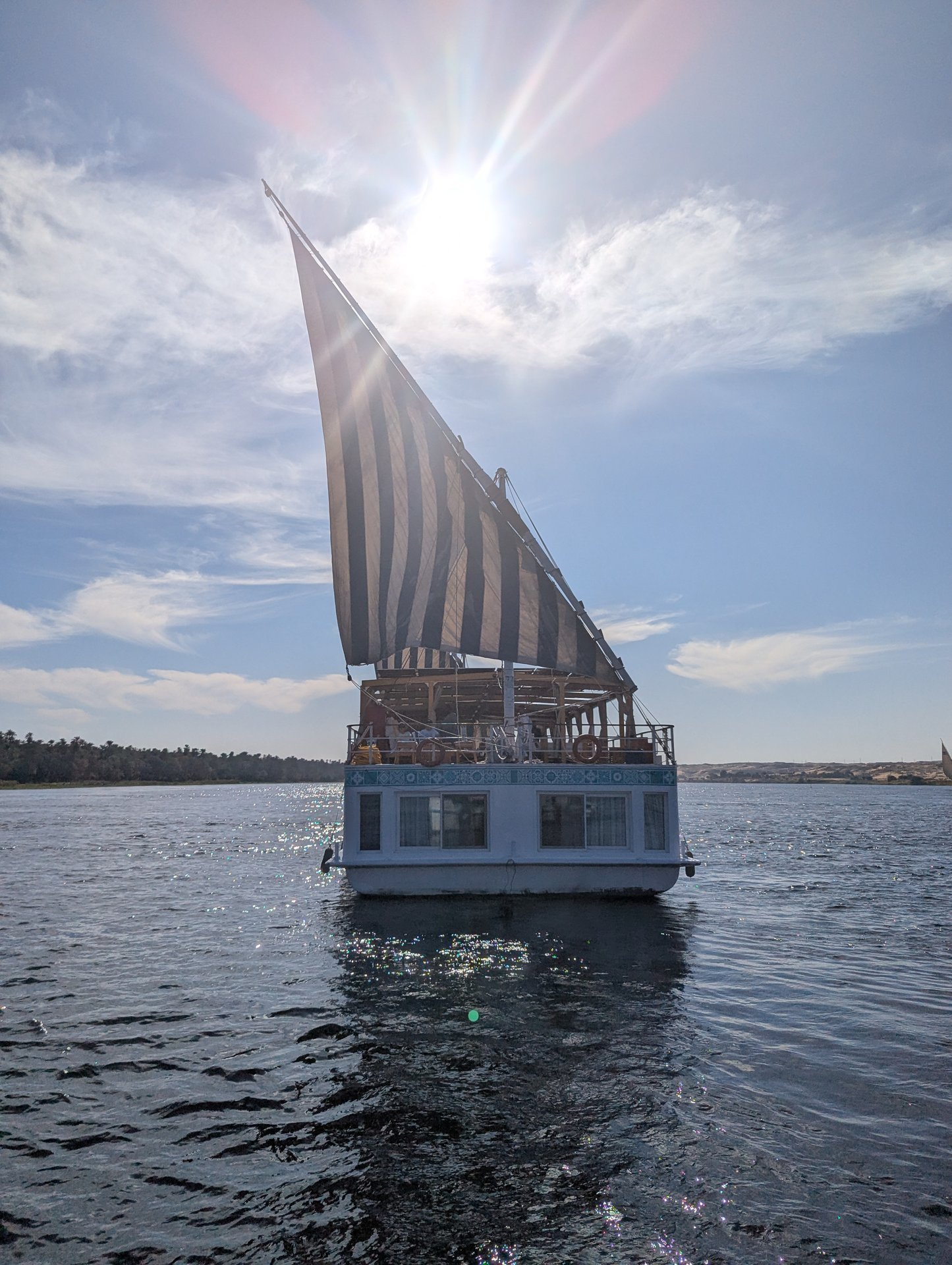 Dahabeya sail backlit by the sun - a romantic Nile voyage in Egypt