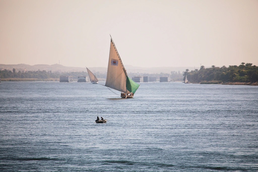 A felucca under sail on the Nile at sunset