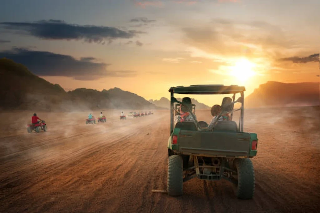 A desert buggy against the low sun on a Red Sea safari track