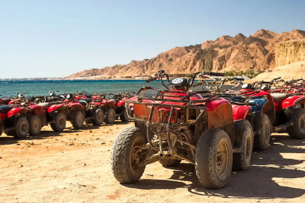 A line of quad bikes parked on the sand before a desert safari near Hurghada