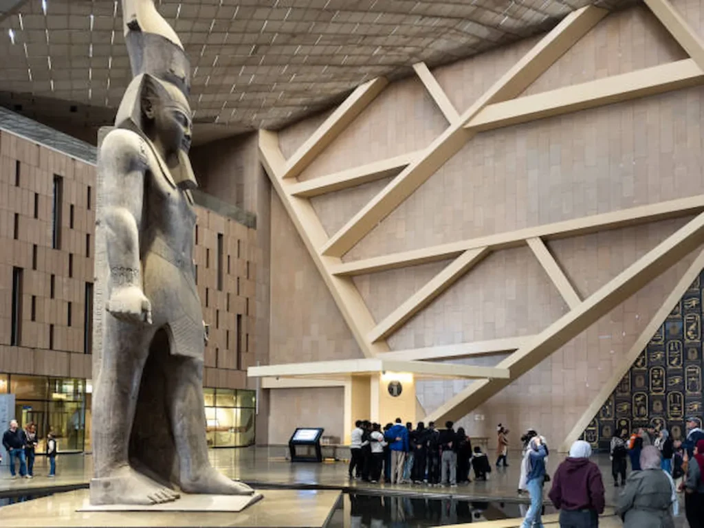 The colossal statue of Ramesses II in the atrium of the Grand Egyptian Museum, at the foot of the Grand Staircase