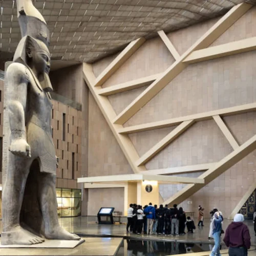 The colossal statue of Ramesses II in the atrium of the Grand Egyptian Museum, at the foot of the Grand Staircase