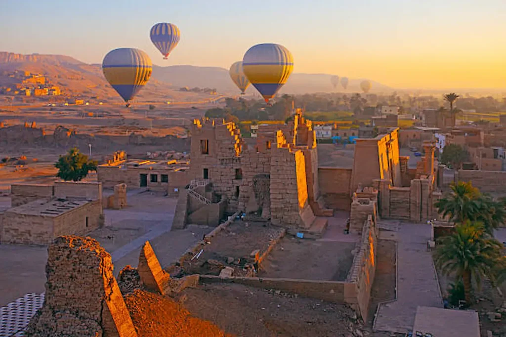 Hot-air balloons over the temples and fields of the Luxor West Bank at sunrise