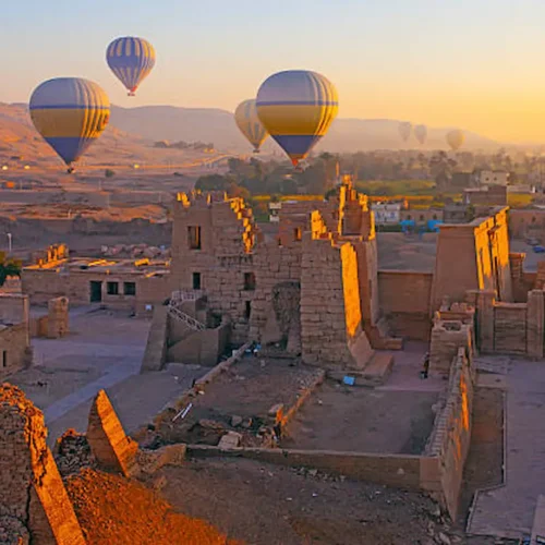 Hot-air balloons over the temples and fields of the Luxor West Bank at sunrise