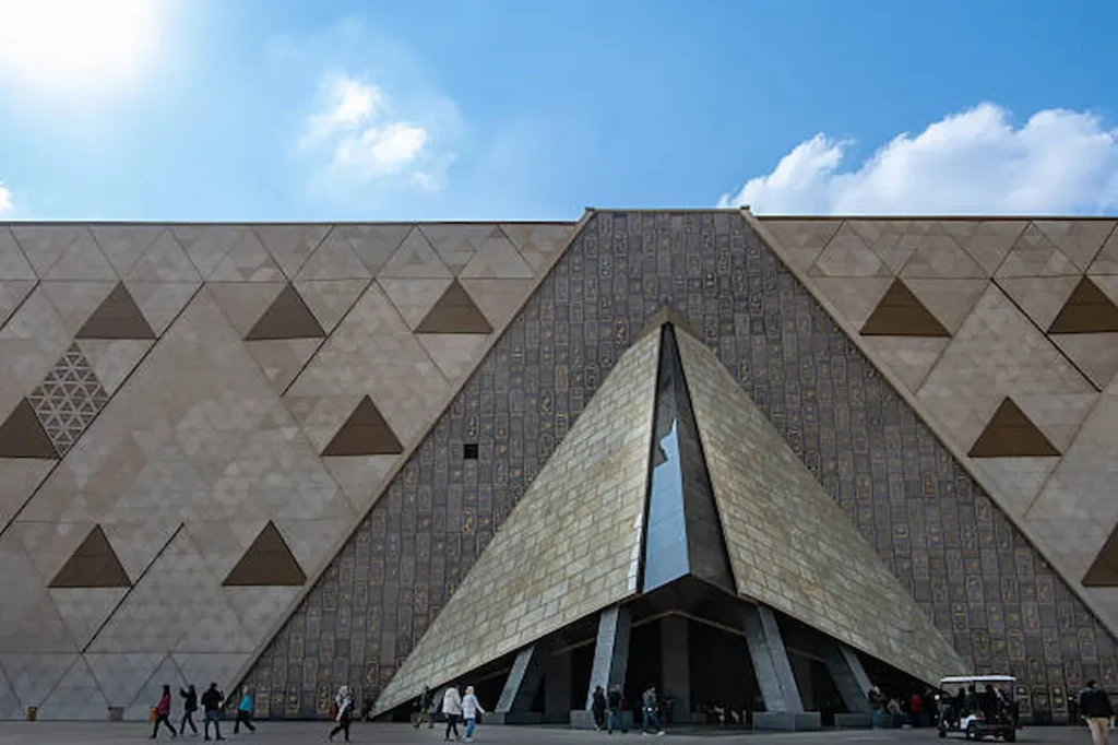 The triangular stone facade of the Grand Egyptian Museum in Giza