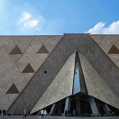 The triangular stone facade of the Grand Egyptian Museum in Giza