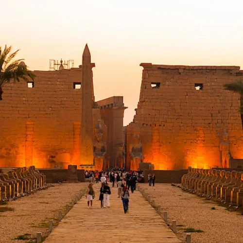 The pylon and obelisk of Luxor Temple lit at dusk